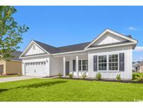 Charming single-story home featuring a two-car garage, welcoming front porch, and manicured lawn at 1209 Cypress Shoal Dr., Conway, SC 29526