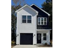 Charming two-story home with modern design, featuring black and white exterior and a well-manicured lawn at 210 26Th Ave. S, Myrtle Beach, SC 29577