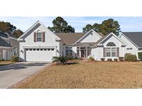 Charming one-story home featuring a manicured lawn, attached garage, and inviting front porch at 126 Pickering Dr., Murrells Inlet, SC 29576