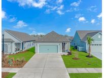 Charming single-Gathering home features a two-car garage, well-manicured lawn, and inviting curb appeal at 1518 Littleleaf Loop, North Myrtle Beach, SC 29582