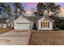 Charming one-story house with a two-car garage and landscaped lawn at 422 Nature Trail Dr., Little River, SC 29566