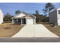 Charming single-story home with a one-car garage and a long driveway and some budding landscaping at 1016 Sw Maple View Rd., Supply, SC 28462