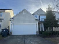Charming two-story home with a two car garage in a residential neighborhood on a sunny day at 128 Fulbourn Pl., Myrtle Beach, SC 29579