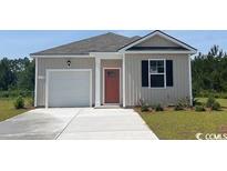 Charming single-story home featuring a one-car garage, red door, and manicured lawn at 218 Carver Willow Dr., Loris, SC 29569