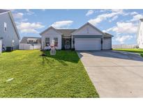 Charming single-story home with a well-manicured lawn, two-car garage, and welcoming blue and white siding at 5037 Sassari St., Myrtle Beach, SC 29579