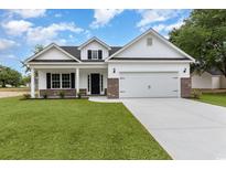 Charming new construction home featuring a two-car garage, black shutters, and a well-manicured lawn at 636 Woodside Dr., Conway, SC 29526