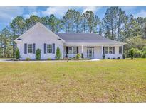 Charming white brick home with a welcoming front porch and well-manicured lawn at 1151 Bear Lake Dr., Longs, SC 29568