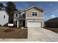 Two-story home with a two-car garage, manicured lawn and neutral color scheme at 528 Tillage Ct., Conway, SC 29526