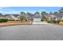 Charming single-story home with gray siding, a two-car garage, and a well-manicured front yard at 158 Regency Dr., Conway, SC 29526
