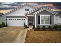 Gray and white two-story house with a two-car garage and landscaping at 2548 Brescia St., Myrtle Beach, SC 29579