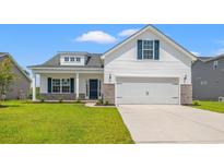 Charming single-Gathering home features a two-car garage, black door, and manicured front lawn at 332 Hayloft Circle, Conway, SC 29526