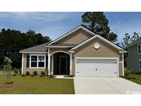 Charming single-story home with a two-car garage, and a welcoming front lawn and meticulously maintained landscaping at 503 Slaty Dr., Myrtle Beach, SC 29588