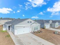 Gray house with a two-car garage and landscaping at 624 Watercliff Dr., Longs, SC 29568