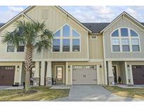 Inviting exterior view of townhome featuring a palm tree and a neutral color scheme at 105 Villa Mar Dr. # C-3, Myrtle Beach, SC 29579