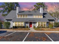 Gray two-story house with red door and landscaping at 1204 Erin Way # 1204-F, Myrtle Beach, SC 29577