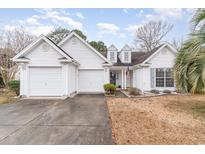 White two-story house with double garage and landscaping at 1228 Lanterns Rest Rd., Myrtle Beach, SC 29579