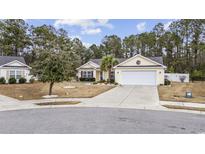 One-story house with a yellow exterior, white garage door, and landscaping at 3368 Merganser Dr., Conway, SC 29527
