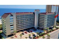 Aerial view of oceanfront building, showing parking and beach at 4719 S Ocean Blvd. # 609, North Myrtle Beach, SC 29582