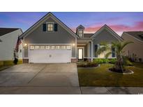 Charming single-Gathering home showcasing a well-manicured lawn, attached garage and traditional architectural design at 6550 Anterselva Dr., Myrtle Beach, SC 29572