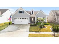 Charming single-Gathering home boasts a well-manicured lawn, a two-car garage, and a welcoming front porch at 6550 Anterselva Dr., Myrtle Beach, SC 29572