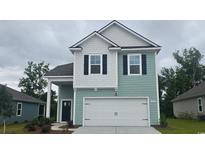 Charming two-story home featuring a 2-car garage, light-blue siding and black window shutters at 1106 Barrington Way, Conway, SC 29526