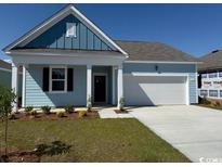 Charming one-story home showcasing light blue siding, a neatly manicured lawn, and a two-car garage at 544 Duvall St., Longs, SC 29568
