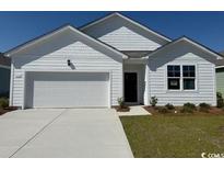Charming one-story home with white siding, manicured lawn, and a two-car garage at 552 Duvall St., Longs, SC 29568