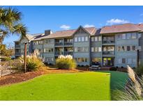 Building exterior showcasing a grassy area and picnic tables at 5905 South Kings Hwy. # 6111, Myrtle Beach, SC 29575