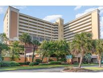 Oceanfront high rise building with palm trees and lush landscaping at 6900 N Ocean Blvd. # 1539, Myrtle Beach, SC 29572
