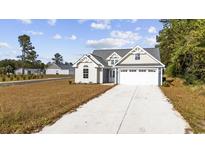 Newly constructed home with a two-car garage and attractive landscaping at 1892 Blue Bird Rd., Loris, SC 29569