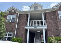 Brick building exterior with white columns and balcony at 2013 Silvercrest Dr. # 30-A, Myrtle Beach, SC 29579