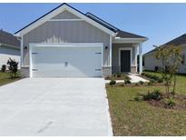 Craftsman style home with white garage door and landscaping at 2039 Copper Creek Loop, Longs, SC 29568