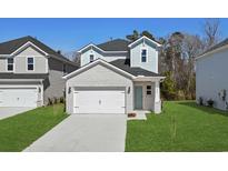 Charming two-story home featuring a brick facade, attached garage, and a well-manicured front lawn at 2048 Copper Creek Loop, Longs, SC 29568