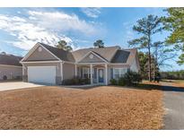 One-story house with a two-car garage and landscaped lawn at 363 Long Meadow Dr., Loris, SC 29569
