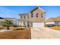 Two-story brick home with a two-car garage and landscaped lawn at 5406 Longhorn Dr., Myrtle Beach, SC 29588
