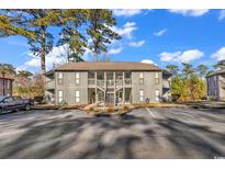 Exterior of a two-story building with parking and landscaping at 859 Tall Oaks Ct. # A, Myrtle Beach, SC 29588