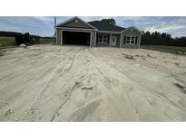 Newly constructed home with a green exterior and attached garage at Tbd 26 Mineral Springs Rd., Conway, SC 29527