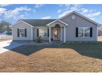 Charming single-story home with a well-maintained lawn and inviting entryway at 1049 Augustus Dr., Conway, SC 29527
