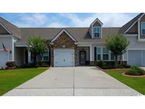 Inviting exterior of charming townhome with stone accents and landscaped yard at 135 Parmelee Dr. # D, Murrells Inlet, SC 29576