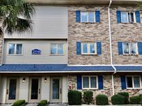 Brick building with blue shutters and a neat lawn at 204 Double Eagle Dr. # C3, Surfside Beach, SC 29575