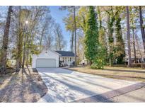 Newly renovated house with a long driveway and mature trees in front at 2409 Causey Dr., North Myrtle Beach, SC 29582