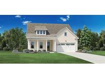 Cream exterior house with a two-car garage and landscaped front yard at 3027 Reamer Dr., Murrells Inlet, SC 29576