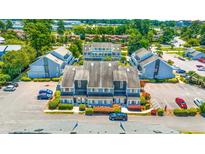 Aerial view of a community of townhouses with ample parking at 3700 Golf Colony Lane # 2-J, Little River, SC 29566