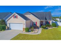 One-story house with beige siding, red shutters, and a two-car garage at 588 Tourmaline Dr., Little River, SC 29566