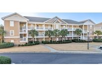 Attractive 3-story condo building with ample parking and landscaping at 6203 Catalina Dr. # 1224, North Myrtle Beach, SC 29582