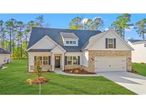 Charming single-story home with brick and white siding, well-manicured lawn, and attached garage at 800 Caines Landing Rd., Conway, SC 29526