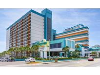 Stunning exterior view of Landmark Resort featuring oceanfront views, palm trees, and covered entrance at 1501 S Ocean Blvd. # 1442, Myrtle Beach, SC 29577