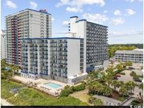 Aerial view of oceanfront resort with pool and parking at 2001 S Ocean Blvd. # 718, Myrtle Beach, SC 29577