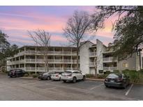 Condo building exterior with parking and landscaping at 415 Ocean Creek Dr. # 2280, Myrtle Beach, SC 29572