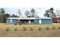 Ranch style home with covered porch and detached garage at 445 W Willow Pond Rd., Johnsonville, SC 29555